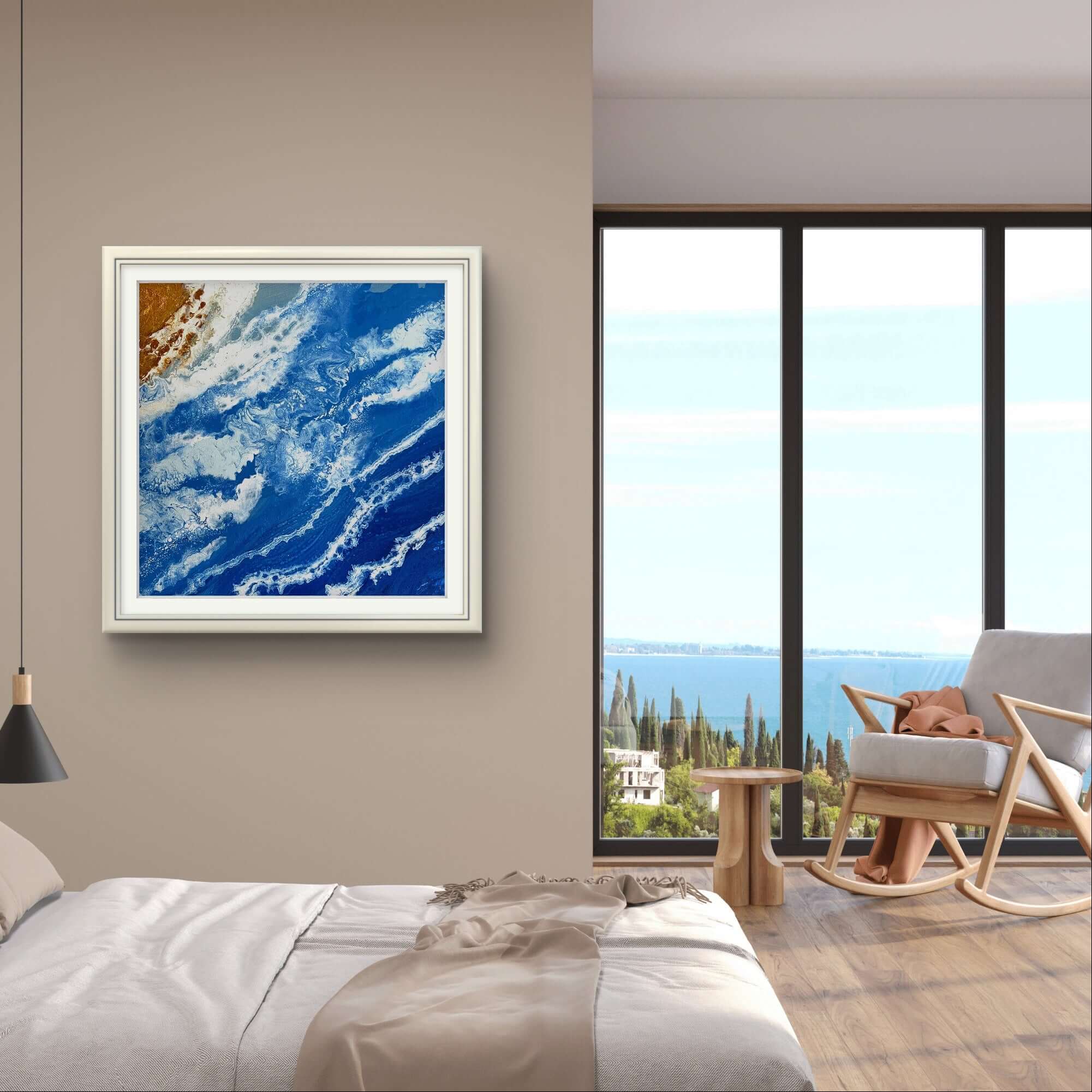 "Golden Shoreline" hand-painted acrylic artwork with blue ocean waves, hanging in a modern room with large window view.