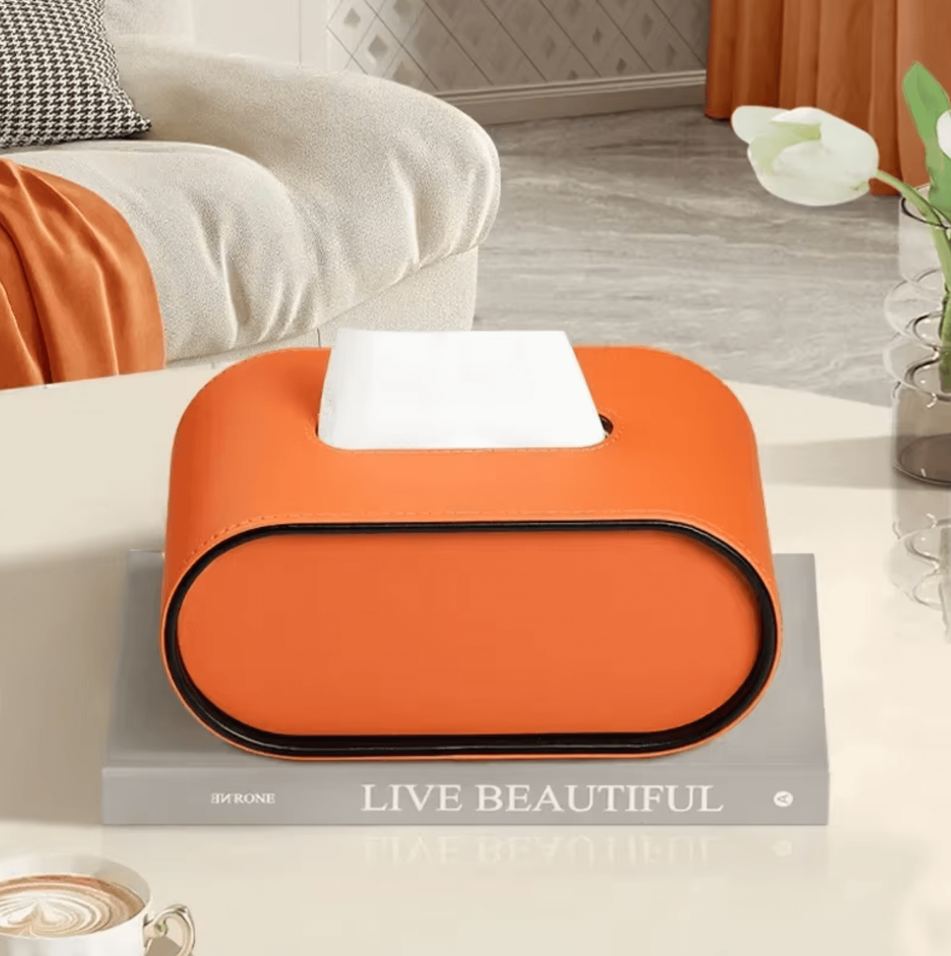 Elegant orange leather tissue box on coffee table enhancing modern home decor.