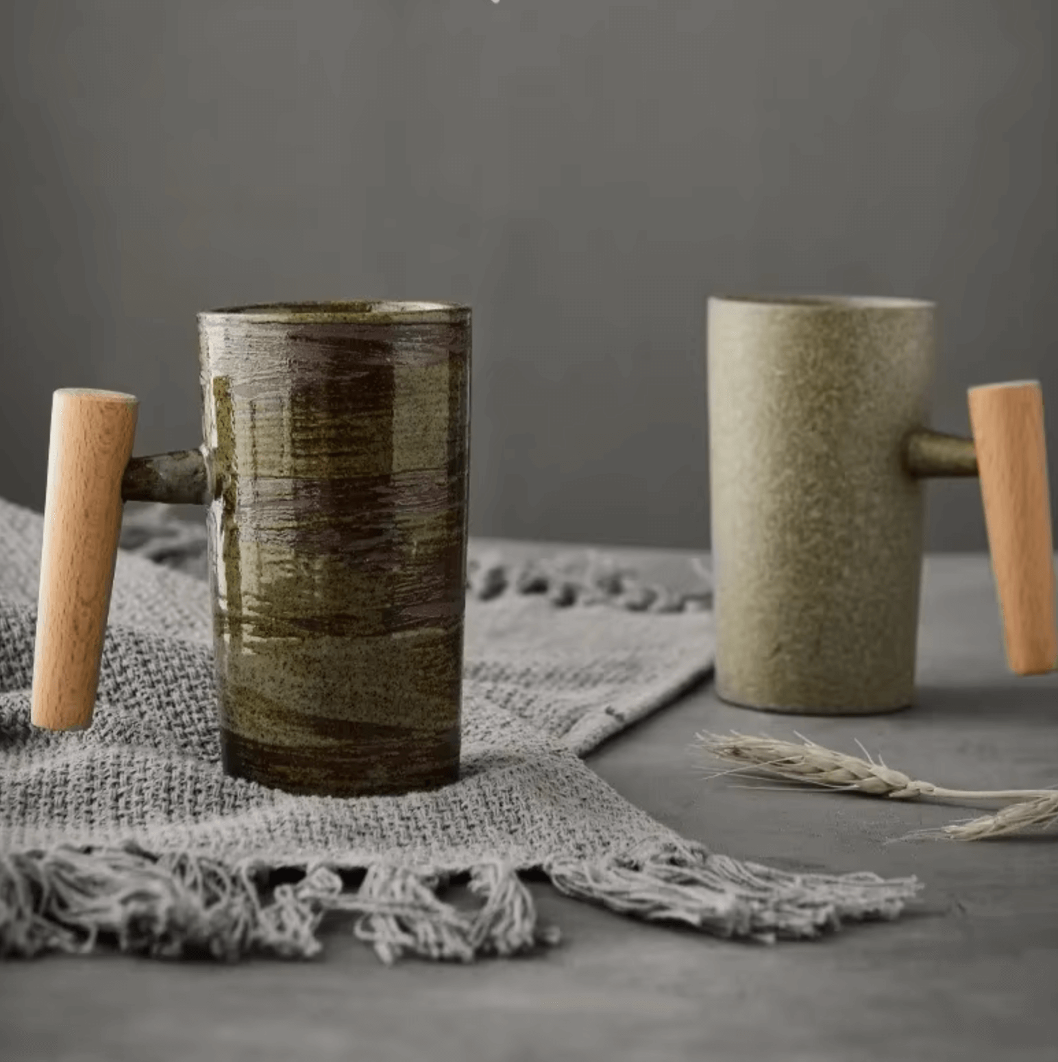 Keramik-Kaffeetasse mit Holzgriff auf grauem Tuch, rustikaler Charme und moderne Eleganz für Genussmomente