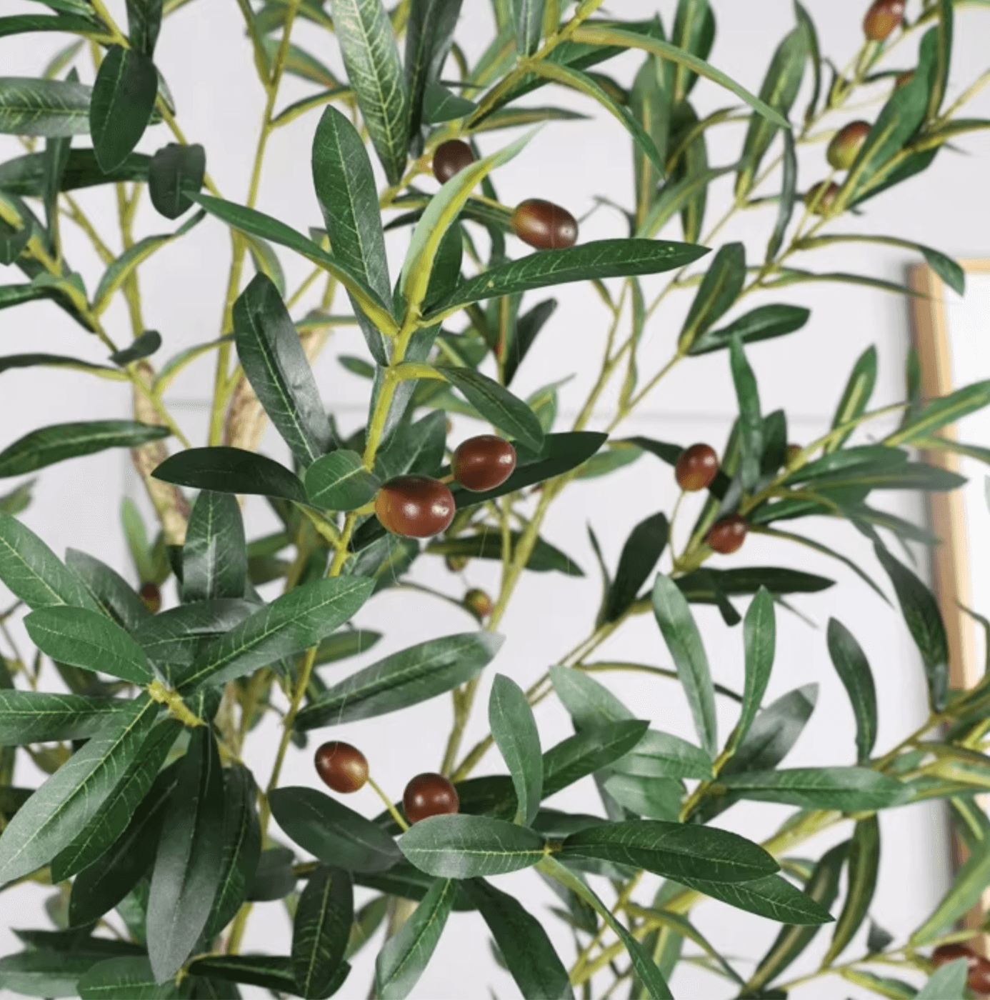 Artificial olive tree with realistic green leaves and olives for home or office decor, available in multiple sizes.