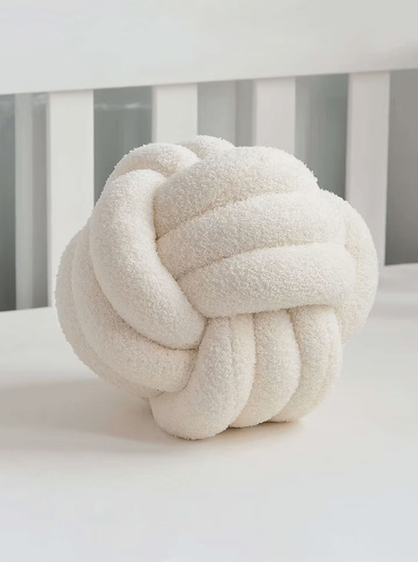 Weißes handgeflochtenes Knotenkissen aus Sherpa-Lammwolle, skandinavisches Design für gemütliche Wohnmomente.