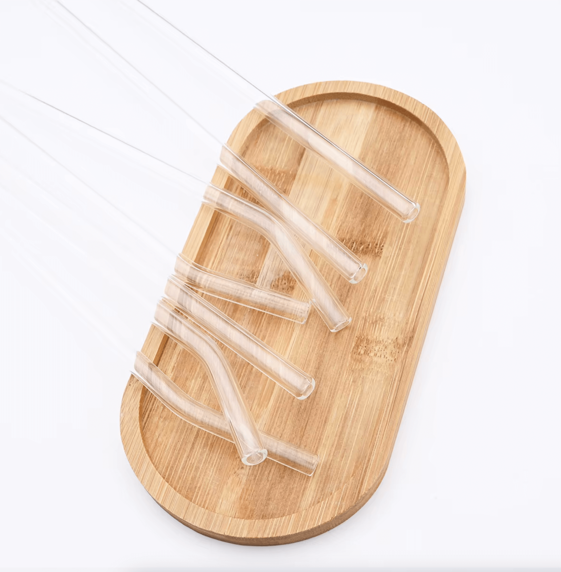 Glasstrohhalm-Set „Pure Sip“ aus klarem Glas auf Bambustablett, stilvoll und umweltfreundlich für nachhaltigen Genuss.