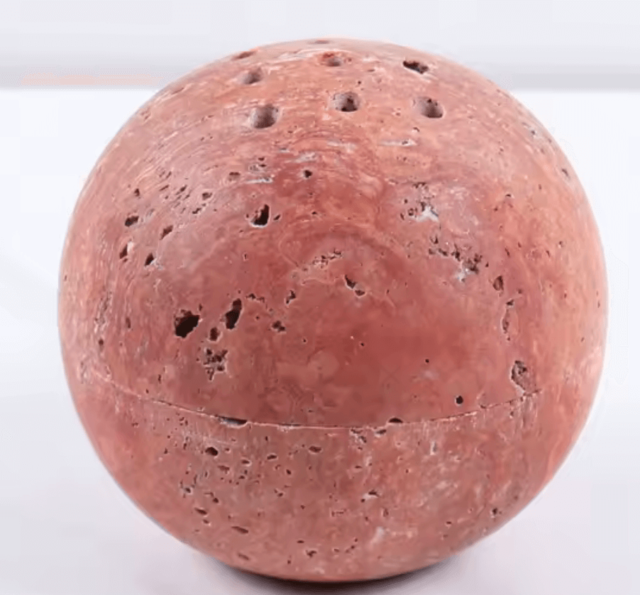 Handcrafted marble incense burner for rituals and well-being, showcasing unique design and natural elegance in a spherical shape.