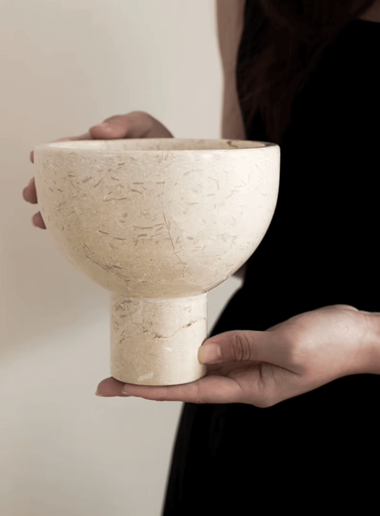 Person holding a luxurious marble bowl in French style, showcasing elegance and functionality in home decor.