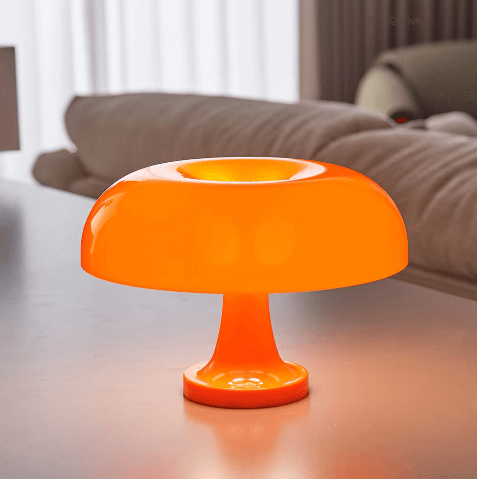 Bauhaus-Pilzlampe in orange on a modern table, showcasing timeless design and USB flexibility, emitting warm ambient light.