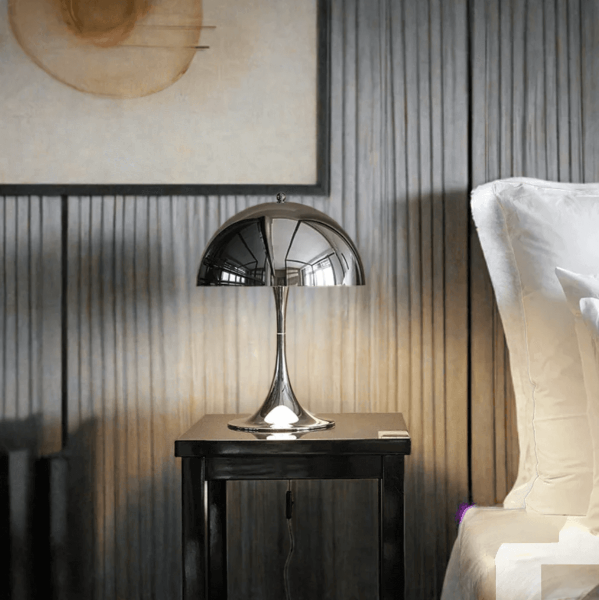 Chrome mushroom table lamp on bedside table, Italian design meets minimalist luxury, adds elegance to modern interior.