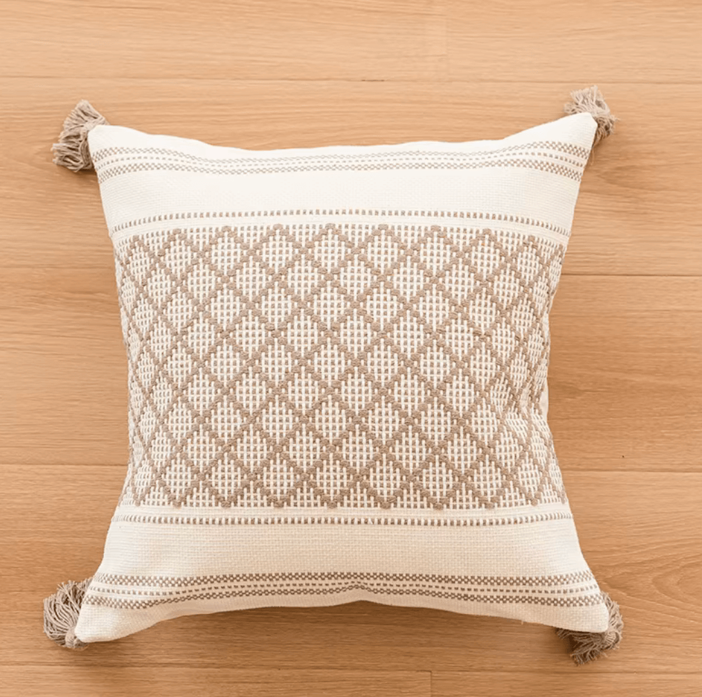 Handmade boho throw pillow cover with diamond pattern, tassels, and neutral beige color, perfect for sofas or beds.