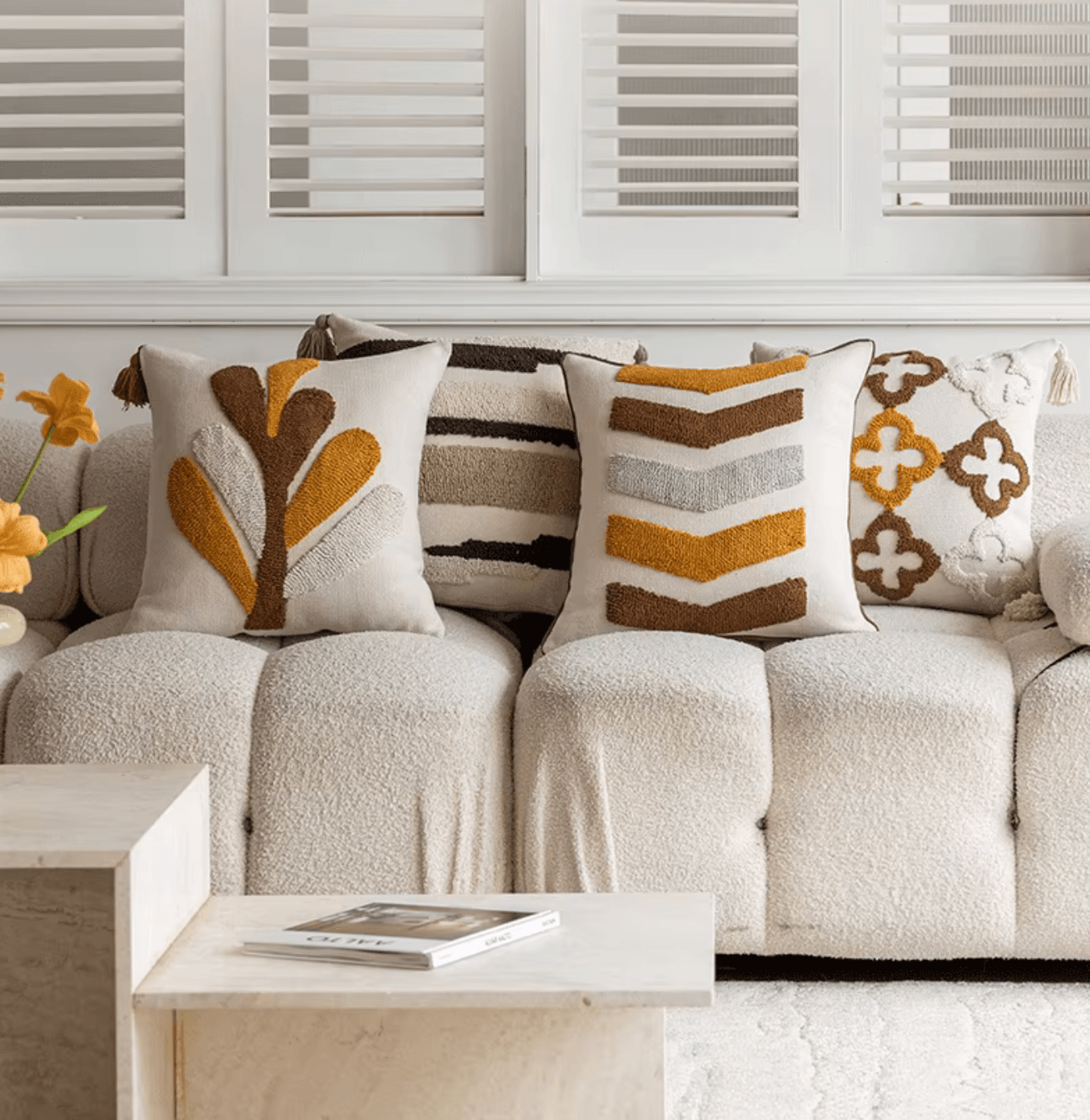 Nordic retro cushion covers with tufted geometric patterns in warm hues on a cozy white sofa, enhancing a Scandinavian interior decor.