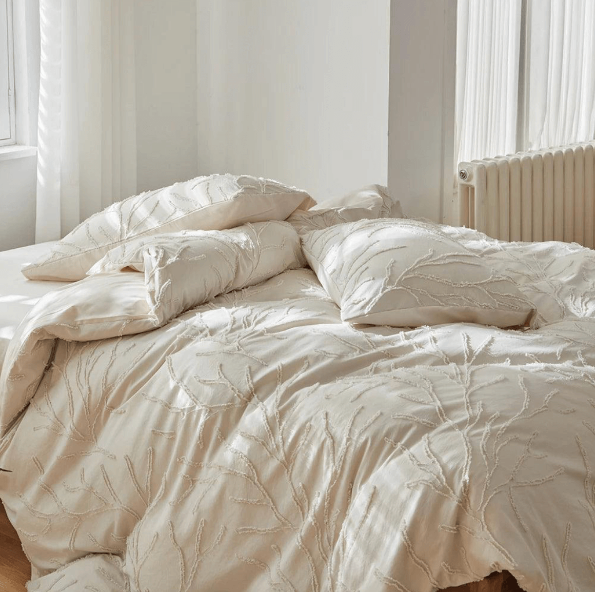 Beige tufted bedding set with boho-chic tree branch design in a bright bedroom, offering natural style and comfort.