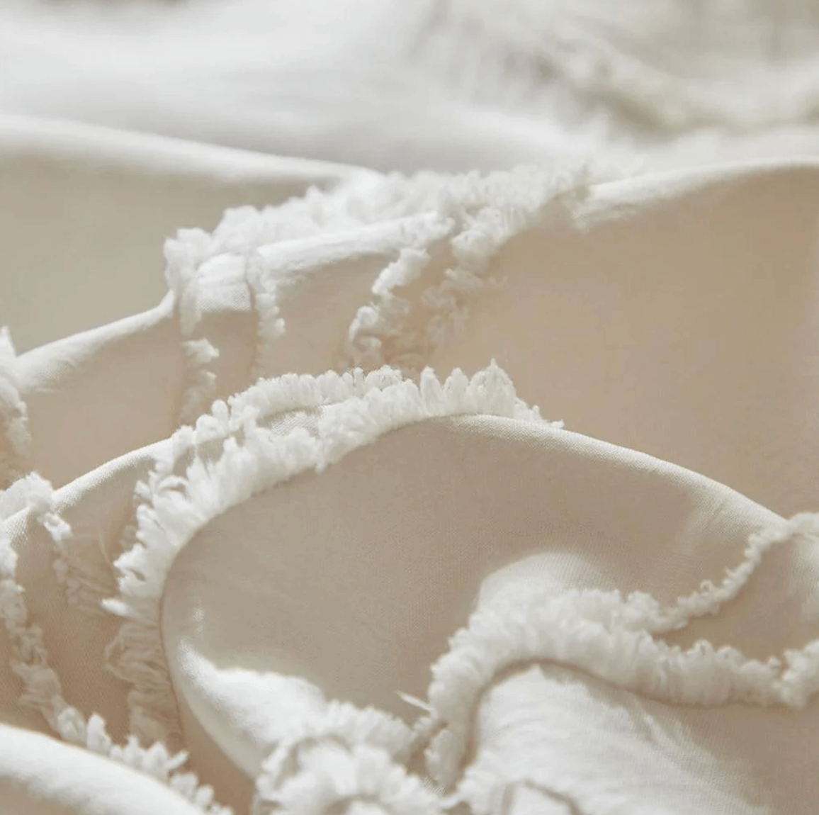 Close-up of beige tufted bedding set with boho-chic tree branch design, showcasing elegant and natural style for modern bedrooms.
