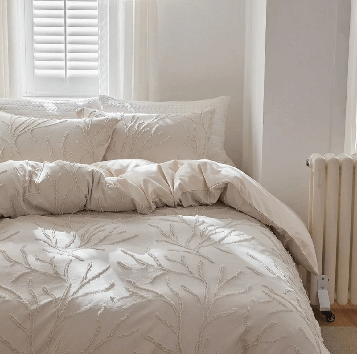 Tufted bed linen set with beige tree branch design, featuring boho-chic style and breathable comfort for a natural bedroom look.