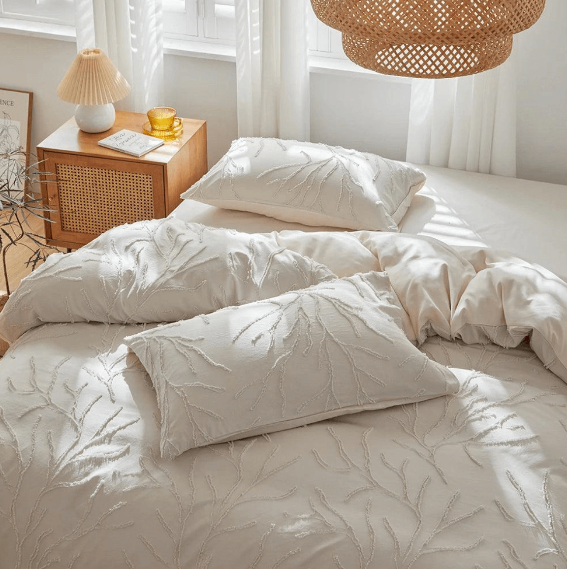 Tufted bedding set with boho-chic tree branch design in beige, styled in a cozy bedroom with natural light and warm decor.