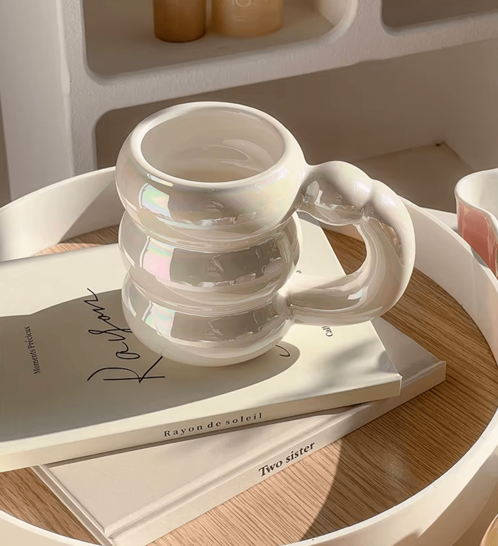 Stylish ceramic mug on a tray with books, showcasing modern Korean-inspired design, ideal for coffee and tea lovers.