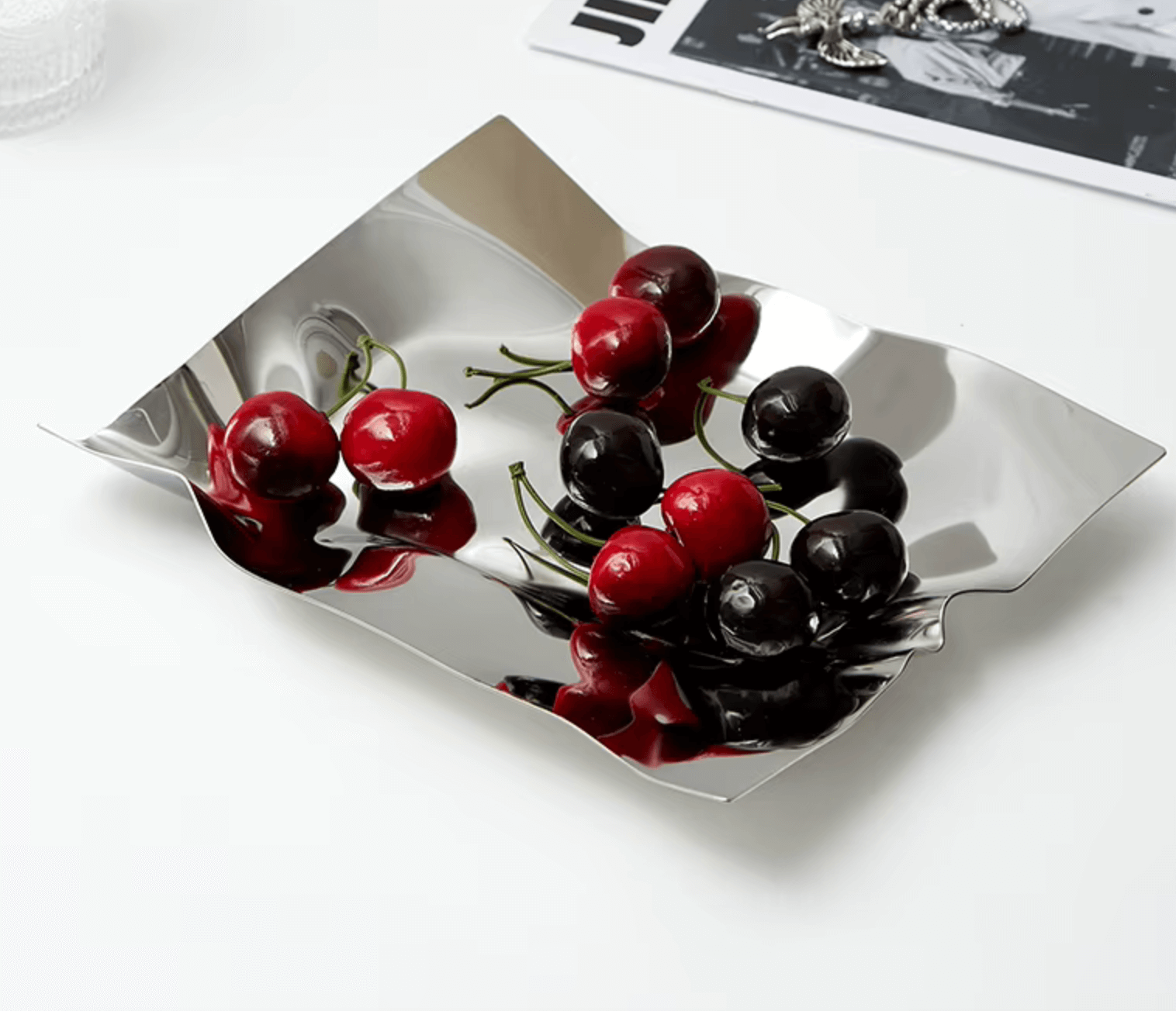 Modern stainless steel tray with red and black cherries, ideal for use as a fruit platter or stylish home organizer.
