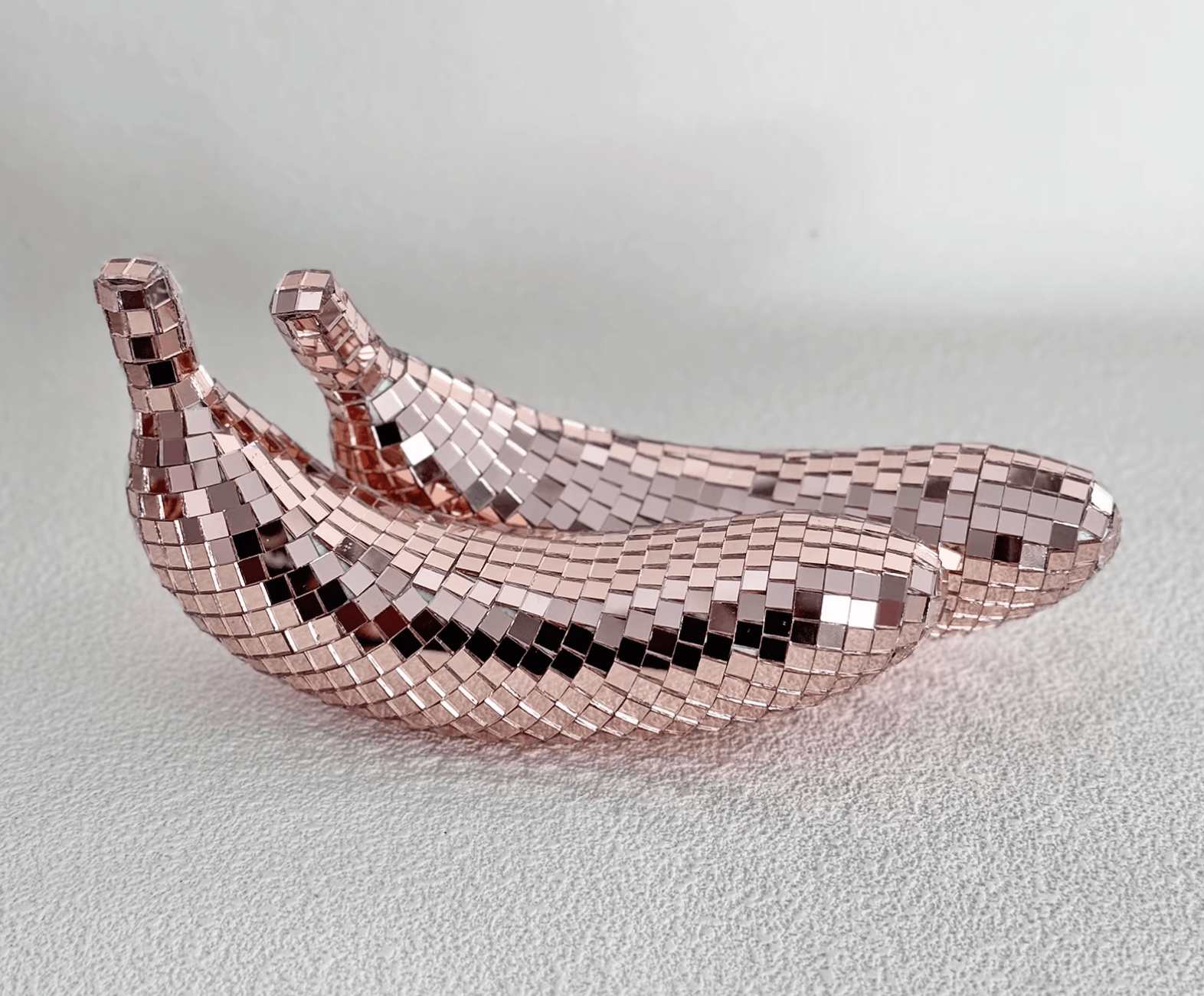 Reflective disco banana decorations in a shimmering pattern, perfect for adding glamour and style to home decor.
