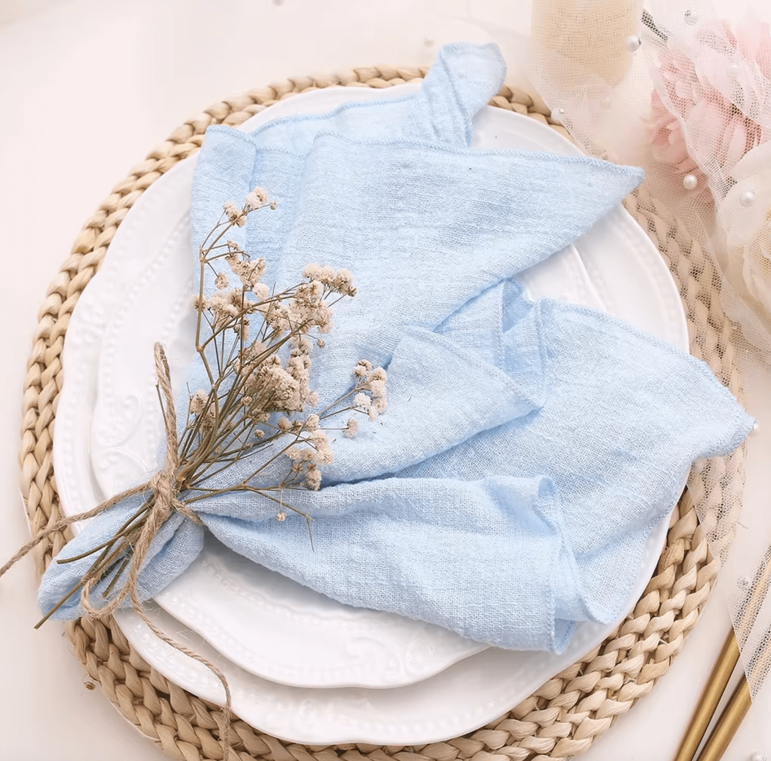 Elegant cotton napkins with delicate floral arrangement on a beautifully set table, perfect for weddings and eco-friendly dining.