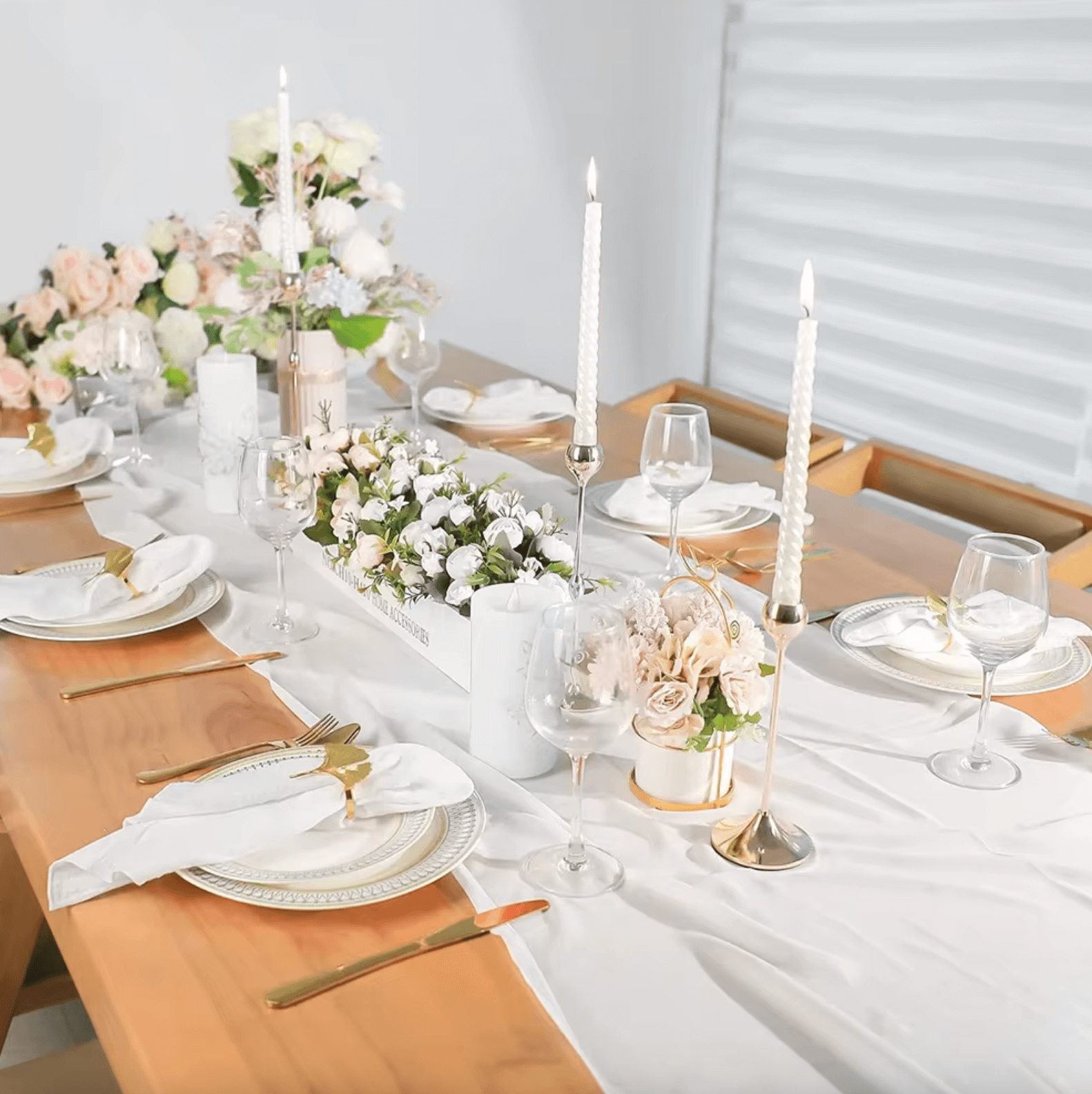 Elegant table setting with cotton napkins, candlesticks, and floral arrangement for weddings or dinner parties.