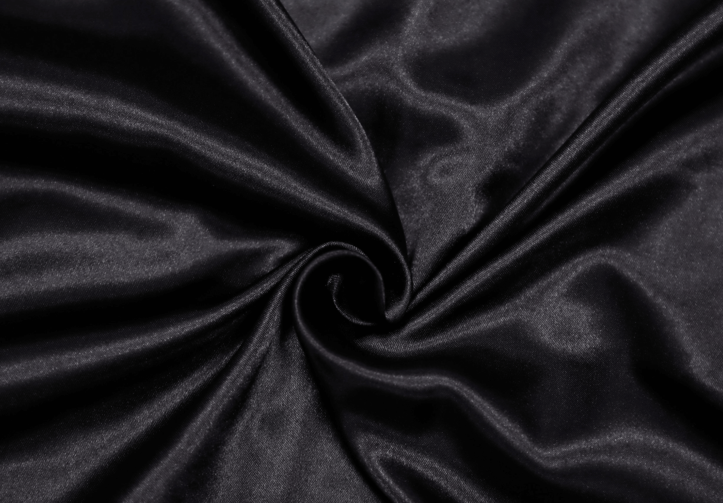 Close-up of luxurious Nordic satin bedding in elegant dark shade, emphasizing soft texture and premium quality.