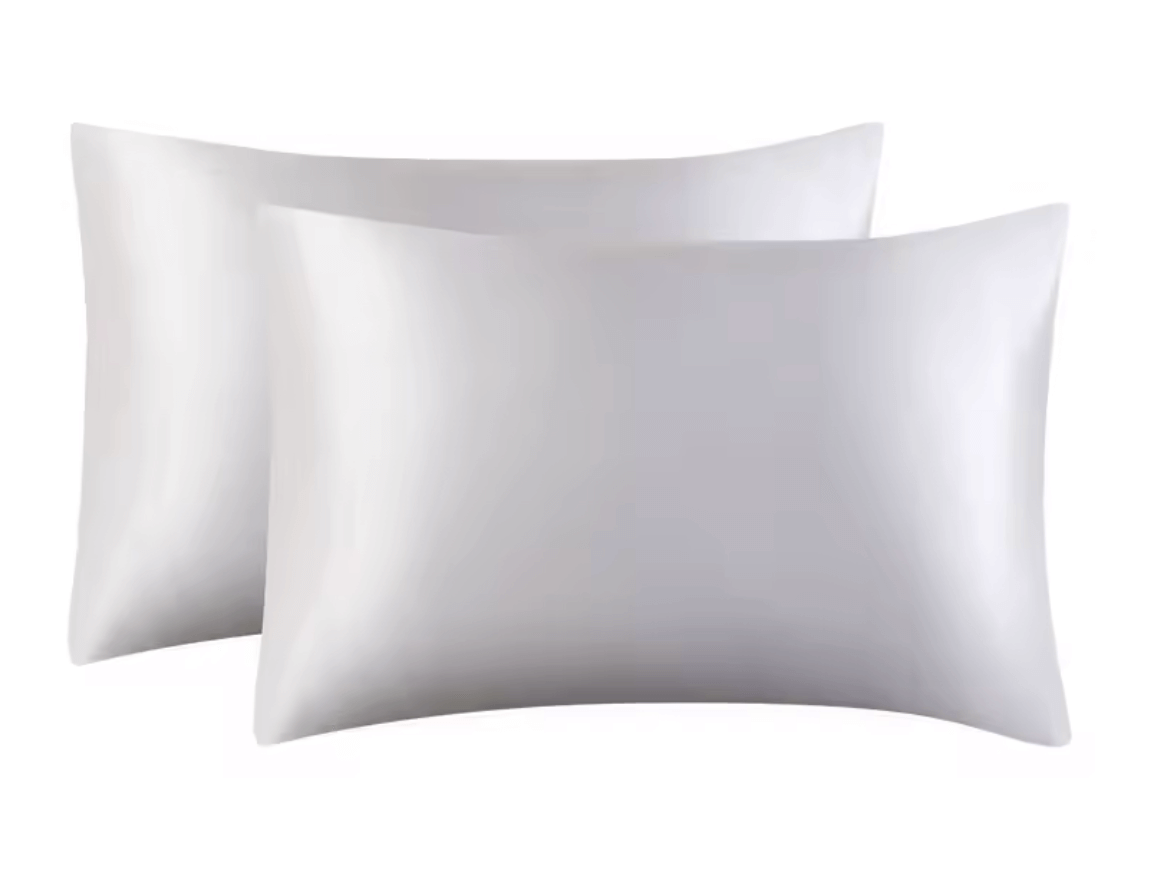 Elegant white satin pillowcases showcasing luxury and comfort for a stylish beauty sleep experience.