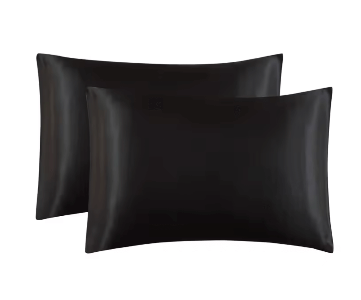 Set of luxurious satin pillowcases in classic black for a glamorous and comfortable beauty sleep experience.