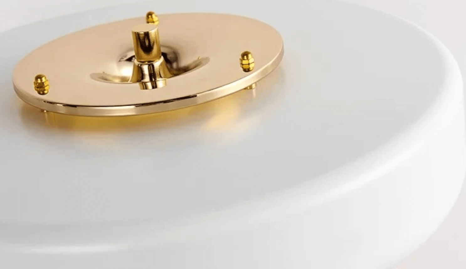 Close-up of the Nordic Glow LED table lamp base featuring gold accents, minimalist design ideal for modern home or office decor.