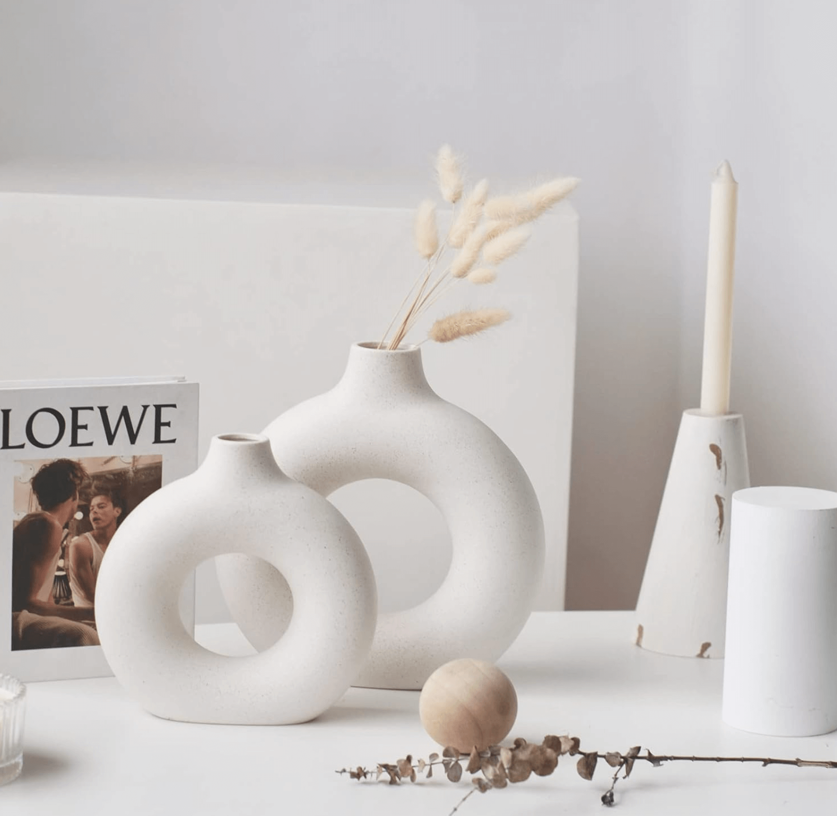 Nordic Vase Duo on a white table with pampas grass, featuring a minimalist design next to a candle and a book for elegant home decor.