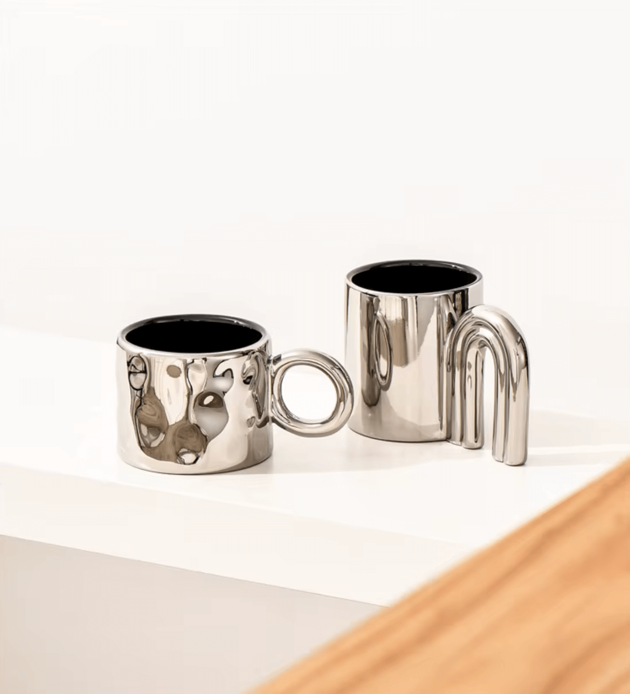 Nordic Elegance ceramic coffee mugs with silver accents on a white surface.
