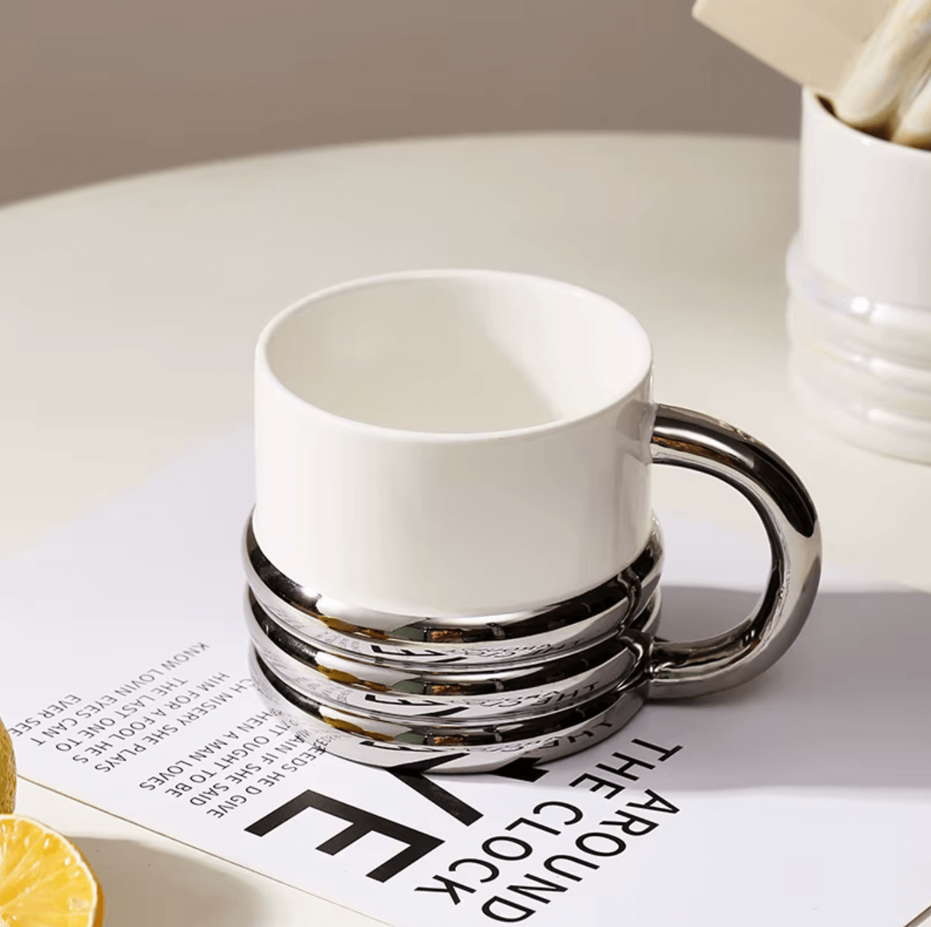 Nordic Elegance ceramic coffee cup with silver accents on a table, showcasing Scandinavian minimalist design.