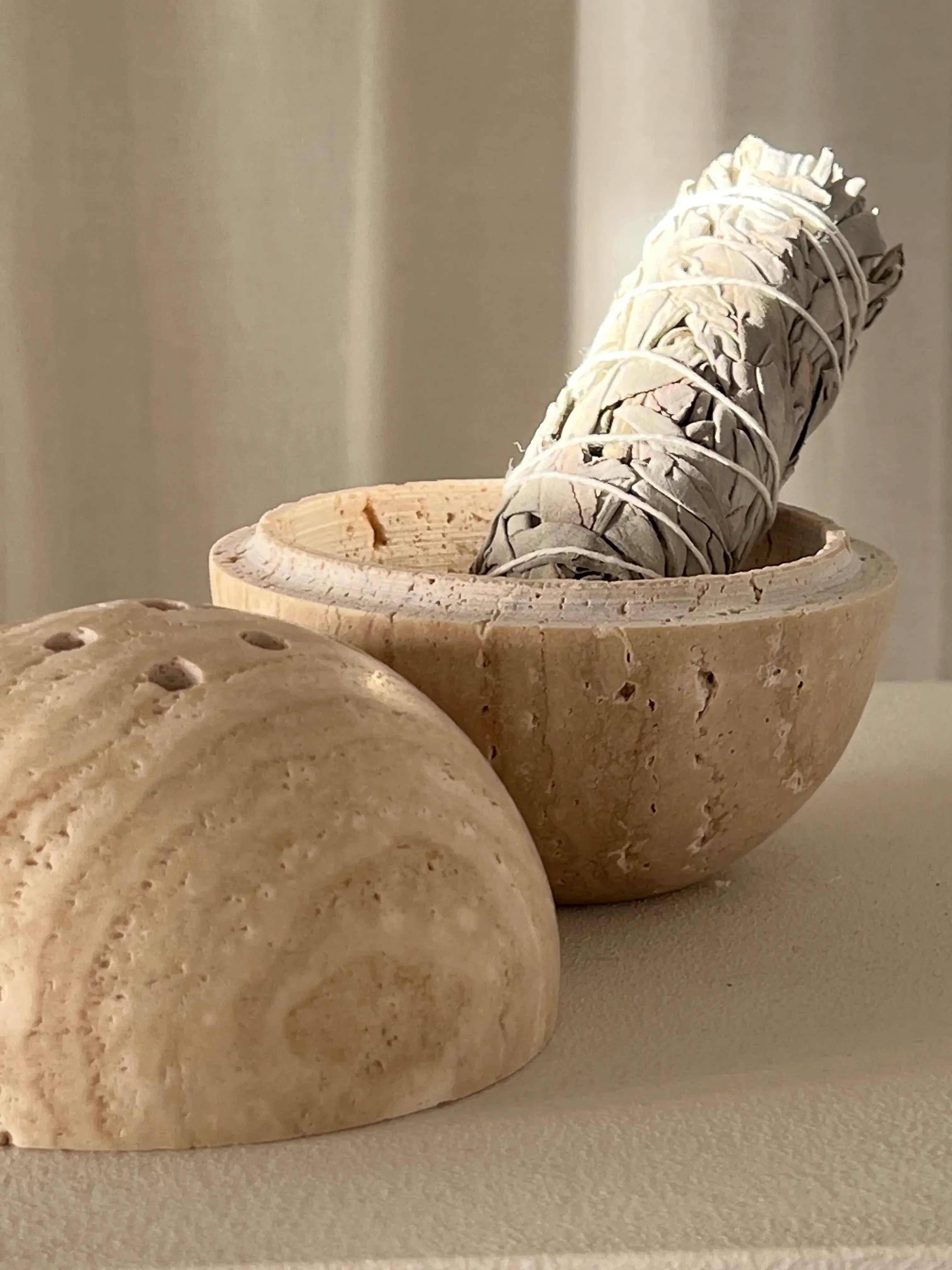 White sage bundle in wooden bowl for spiritual cleansing and clarity. Ideal for rituals, meditation, and energy purification.