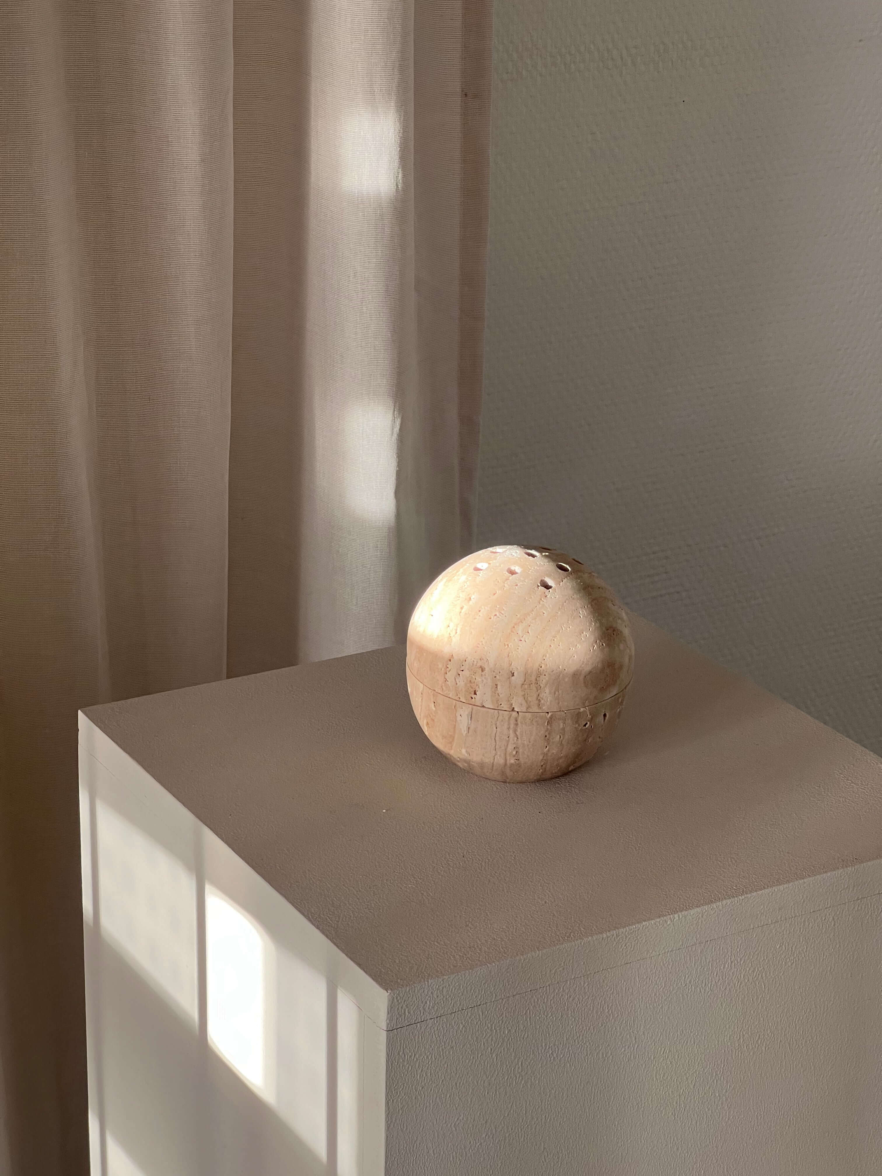 Handcrafted marble incense burner for rituals and relaxation, showcasing natural elegance and functional design on a pedestal.