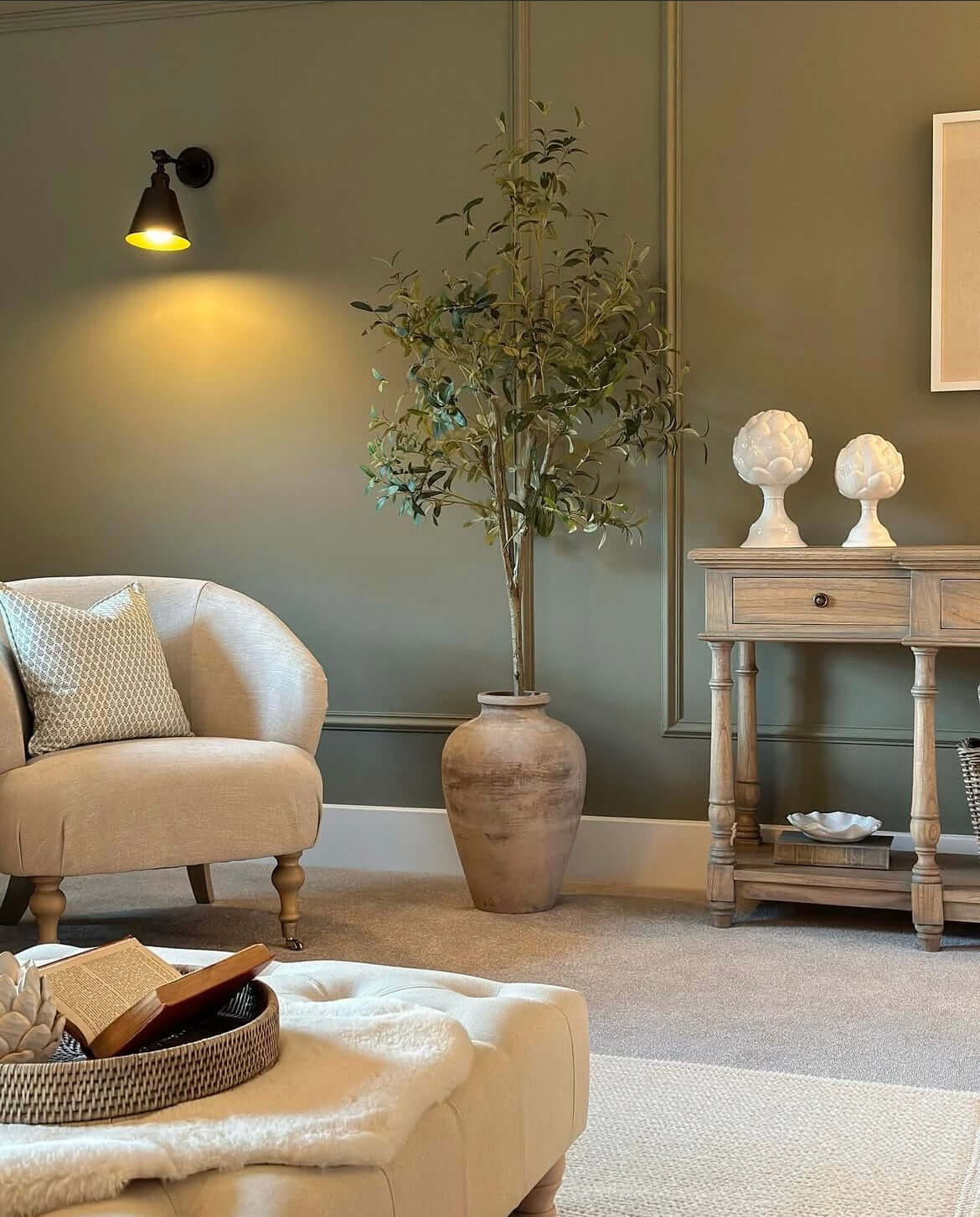 Elegant artificial olive tree in a living room, enhancing natural decor without maintenance. Ideal for home or office spaces.