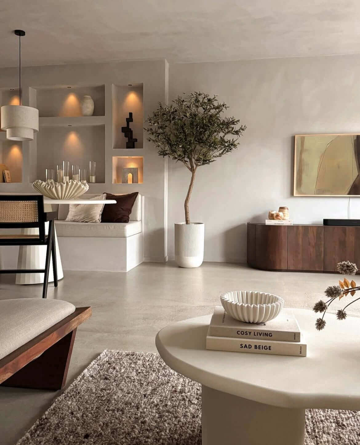 Modern minimalist living room with cozy decor, indoor plant, and warm lighting. Elegant neutral tones and stylish furniture. 🌿🏡