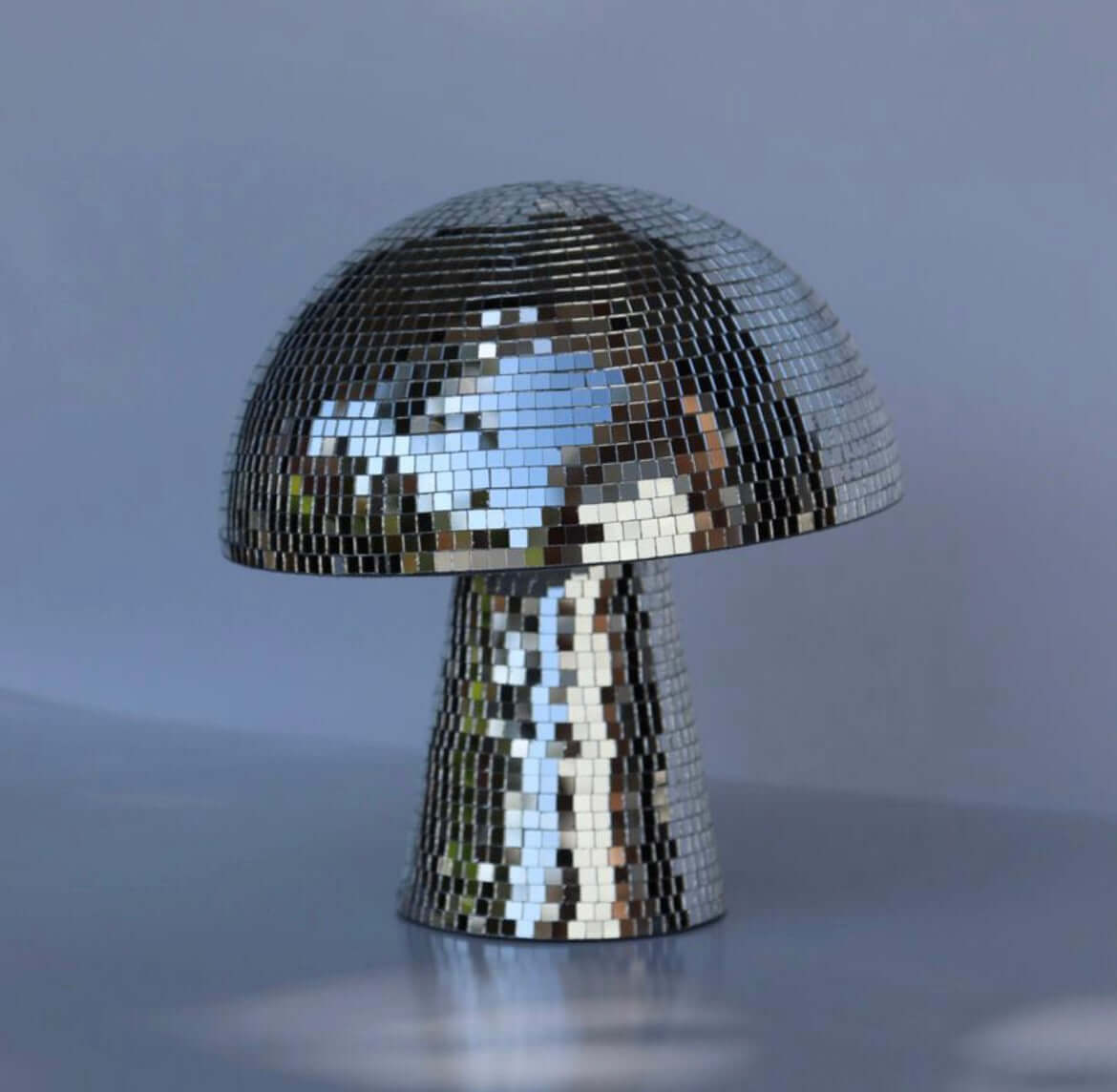 Retro disco mushroom with mirror tiles reflecting light, perfect for home and party decoration.